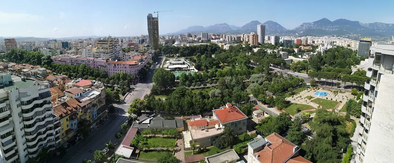 Panoramic daytime view of Tirana with Rinia Park, TID Tower and Dajti mountain