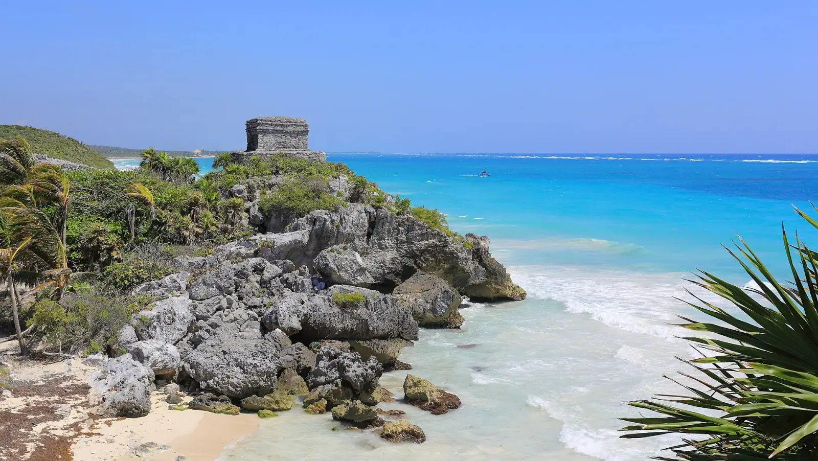 Temple of the Wind God at Tulum perched on cliffs above the turquoise Caribbean Sea