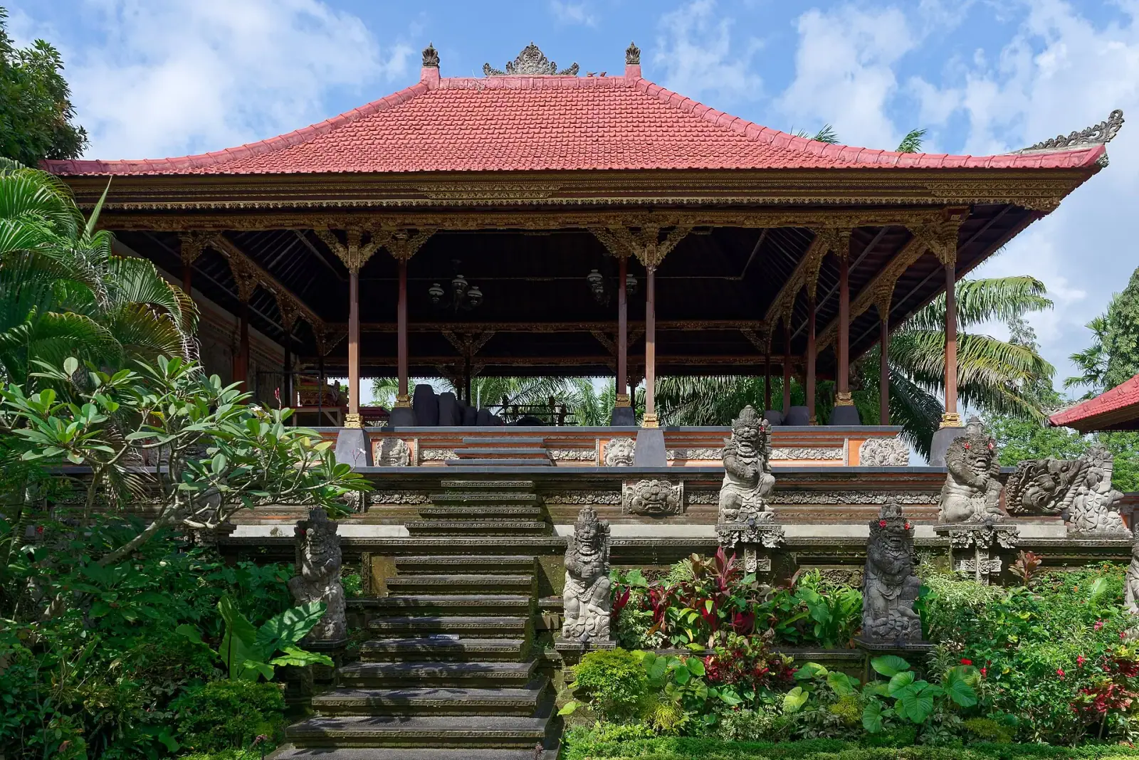 Ubud Royal Palace (Puri Saren Agung) with carved stone guardian statues and traditional Balinese pavilion, Ubud, Bali