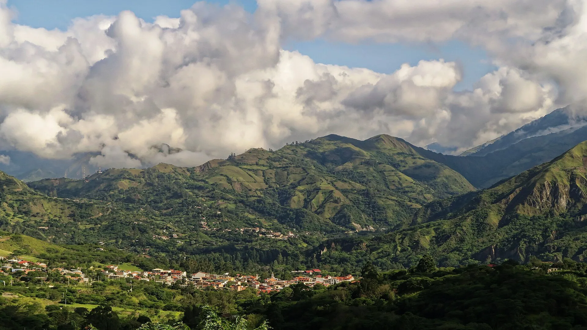 Vilcabamba town in its Andean valley with terracotta rooftops and green mountains, Ecuador