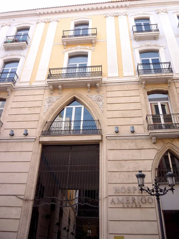Ornate historic facade of Hospes Amerigo boutique hotel in Alicante with hotel name sign on the building
