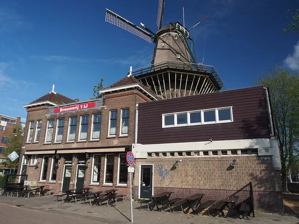 Brouwerij 't IJ craft brewery exterior with De Gooyer windmill, Amsterdam