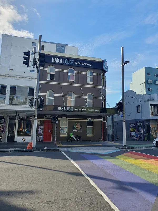Haka Lodge Backpackers on Karangahape Road, Auckland, with rainbow crosswalk at corner