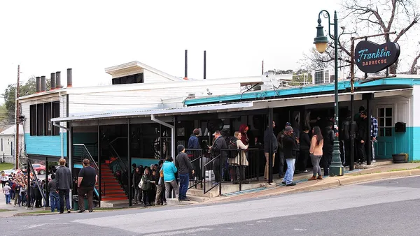 Franklin Barbecue exterior on 11th Street Austin with customers lining up before opening