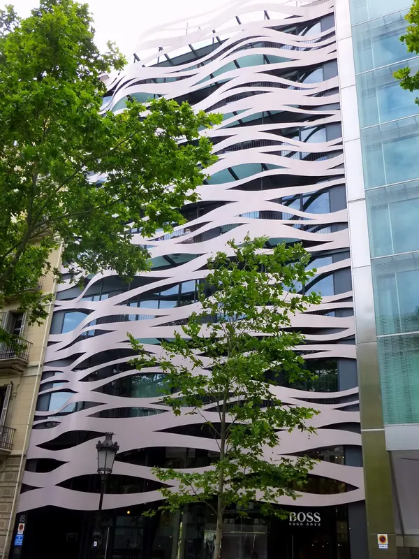 Suites Avenue aparthotel exterior with Toyo Ito wave facade at Passeig de Gracia 83, Barcelona