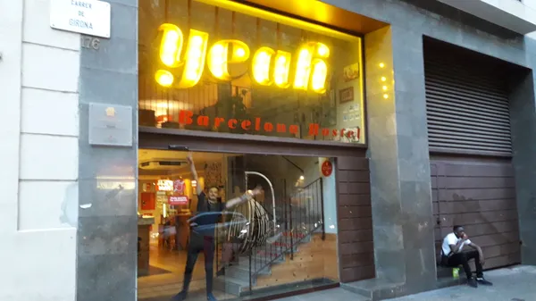 Yeah Barcelona Hostel storefront with neon sign on Carrer de Girona