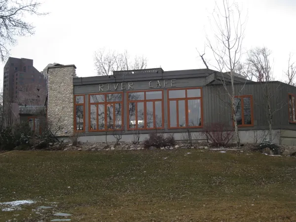 Exterior of River Cafe in Prince's Island Park Calgary showing RIVER CAFE signage and large windows