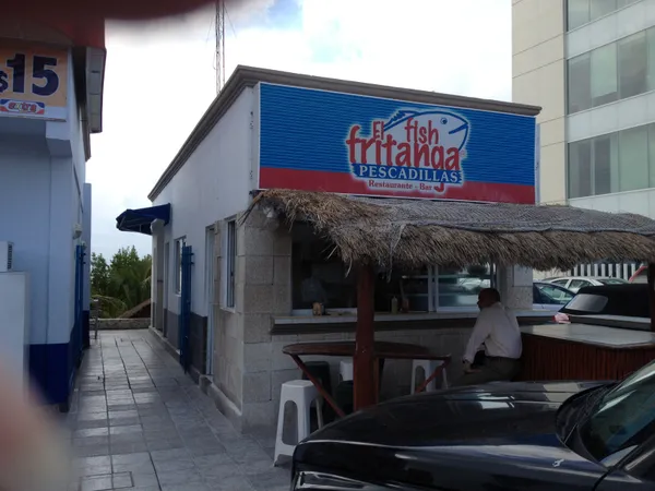 Exterior of El Fish Fritanga restaurant with its blue-and-red sign, Cancún