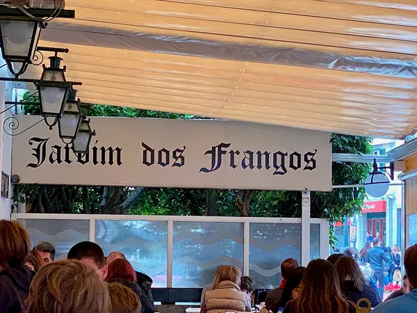 Jardim dos Frangos restaurant sign above outdoor terrace in Cascais