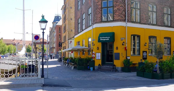 Christianshavns Faergecafe yellow corner building with green awning on Christianshavn canal