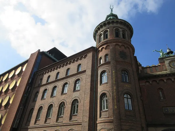 Hotel Ottilia exterior, red-brick 1881 building with tower in Carlsberg City Copenhagen