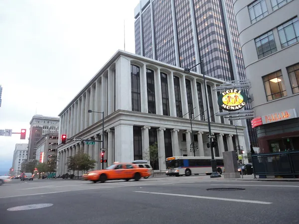 Exterior of Hotel Monaco Denver at 17th Street showing the illuminated Hotel Monaco sign