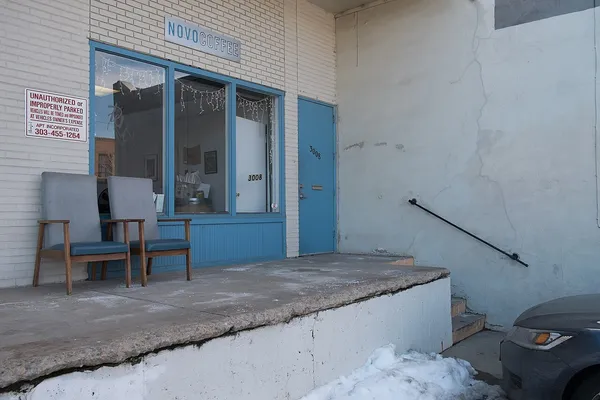 Exterior of Novo Coffee in Denver with signage visible above the blue-trimmed storefront