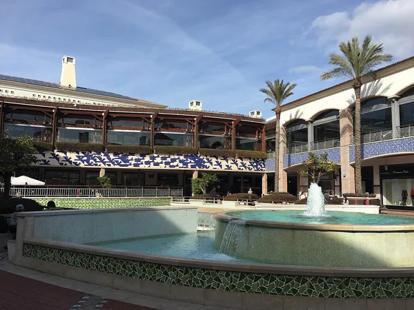 Outdoor courtyard of Forum Algarve shopping centre with fountain and stores