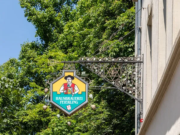 Ornate wrought-iron hanging sign reading Hausbrauerei Feierling at the Freiburg brewpub
