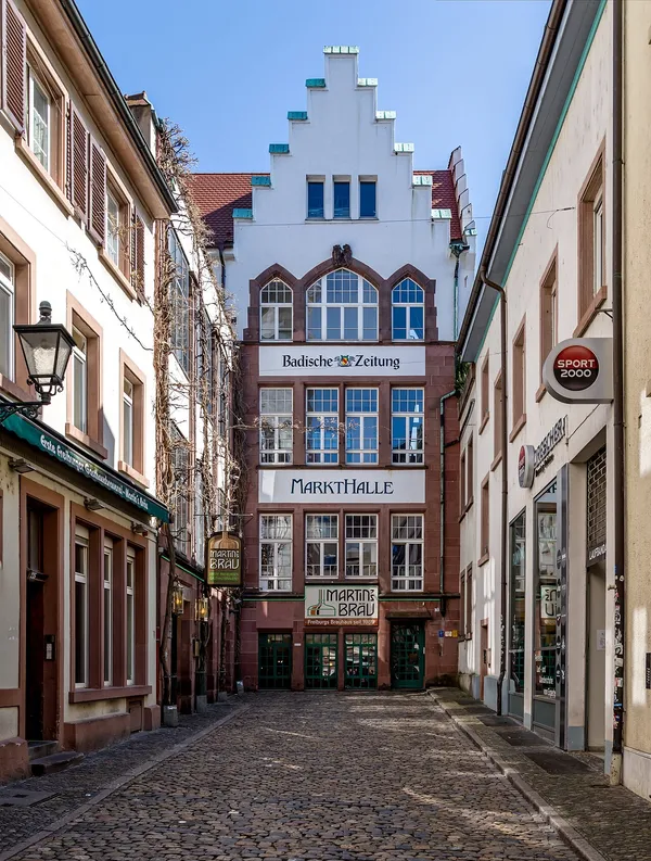 Exterior facade of Markthalle Freiburg on Martinsgässle showing the market hall building with prominent signage