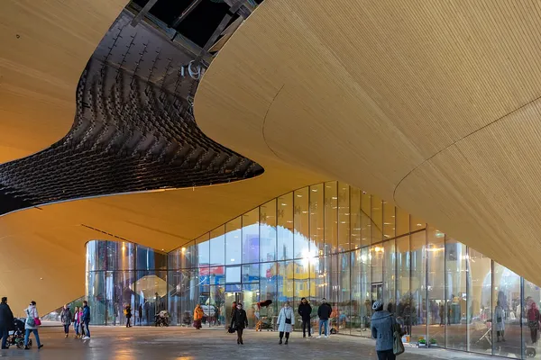 Interior of Helsinki Central Library Oodi showing its distinctive curved wooden ceiling