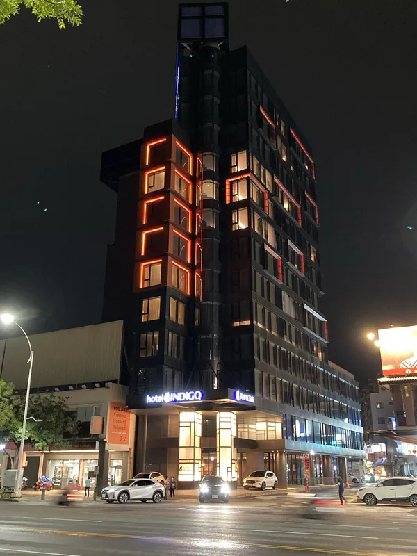 Hotel Indigo Kaohsiung Central Park exterior at night with illuminated signage
