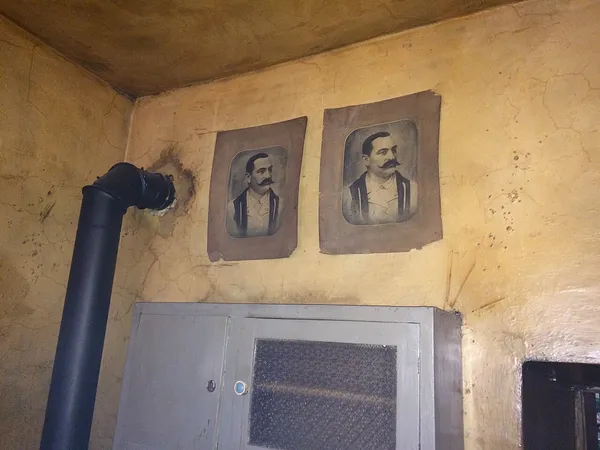 Interior of Eszeweria bohemian bar, Kazimierz, Krakow, with vintage portraits on aged plaster walls
