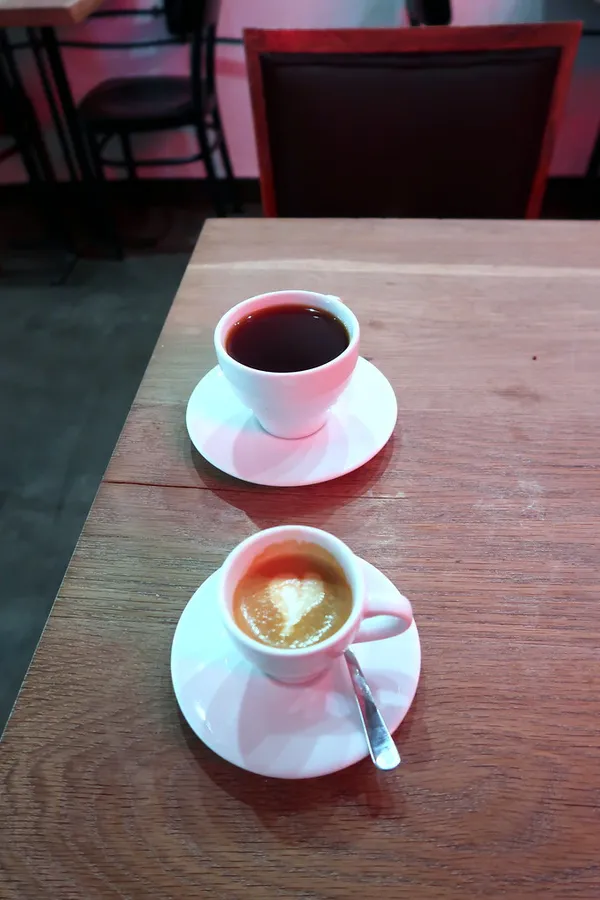 Coffee cups on a wooden table inside Cafe Tektura, Krakow