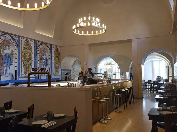 Interior of Cervejaria Trindade with historic azulejo panels and vaulted ceiling