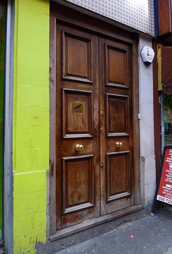 The discreet wooden entrance door of Nightjar cocktail bar on City Road, Shoreditch