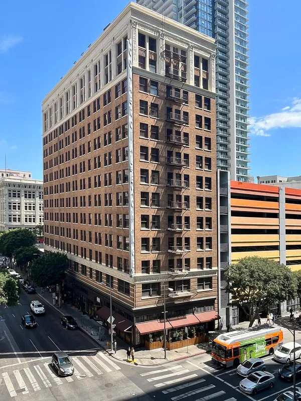 Exterior of the Commercial Exchange Building, a 13-story historic brick building in Downtown Los Angeles that houses the Freehand Hotel