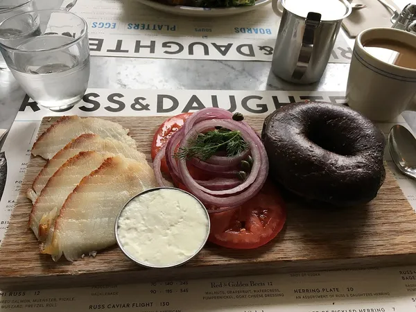 Smoked fish and pumpernickel board on Russ and Daughters Cafe branded menu paper