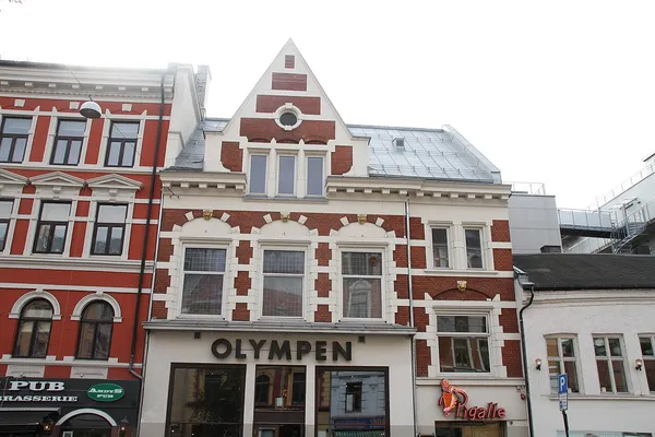 Victorian red-brick exterior of Olympen restaurant with signage in Oslo