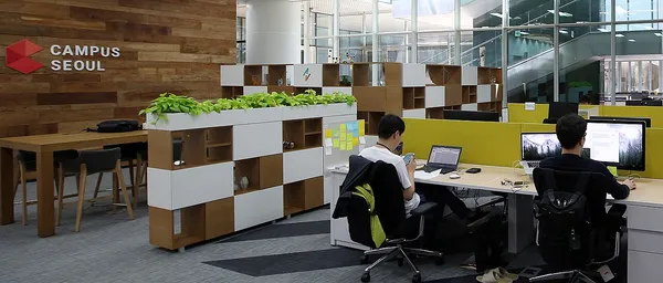 Interior of Google for Startups Campus Seoul coworking space, showing the Campus Seoul branding and people working at desks
