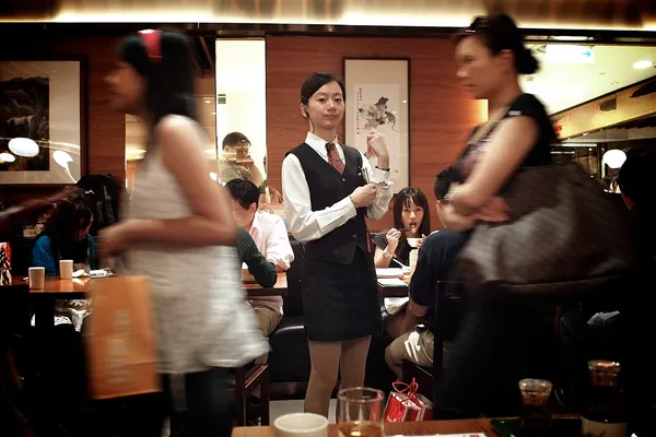 Interior of Din Tai Fung restaurant in Taipei with staff and diners
