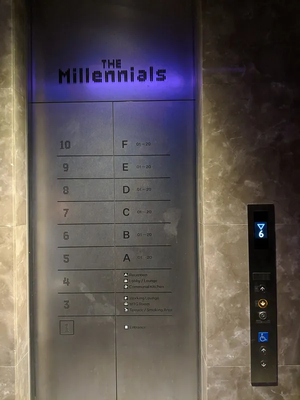 Elevator directory panel inside The Millennials Shibuya hotel showing floor-by-room layout with hotel name in LED lettering