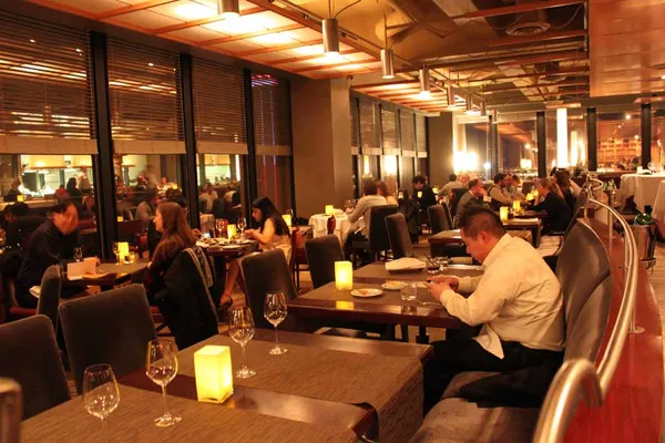 Interior of Canoe Restaurant Toronto showing fine dining room with warm lighting and floor-to-ceiling windows