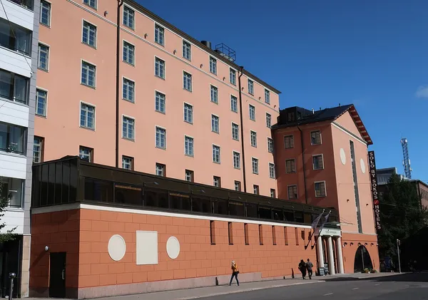 Exterior facade of Solo Sokos Hotel Turun Seurahuone in Turku city centre, a salmon-pink multi-storey building with SOLO BY SOKOS HOTELS signage