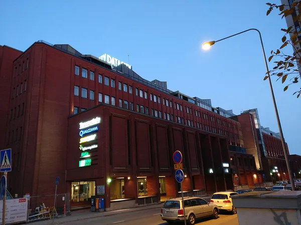 DataCity building in Kupittaa, Turku, a large red brick multi-storey office complex with illuminated rooftop DATACITY sign at dusk