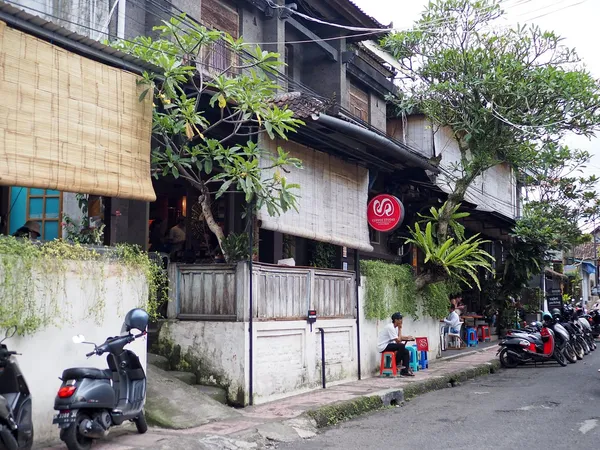 Seniman Coffee Studio exterior in Ubud, Bali, with red circular logo sign