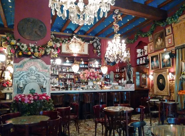 Ornate baroque interior of Cafe de las Horas Valencia with crystal chandeliers and antique portraits