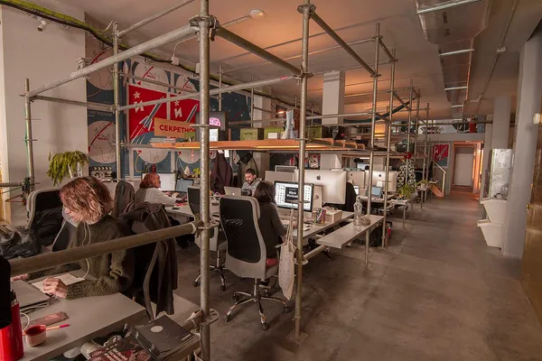 Interior of Nolich coworking space in Valencia, showing open-plan desks and mural wall art