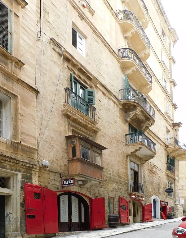 Exterior of Legligin wine bar on Santa Lucia Street, Valletta, with distinctive red doors and Legligin signage
