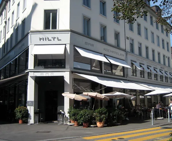 Hiltl restaurant exterior with white awnings and outdoor terrace, Zurich
